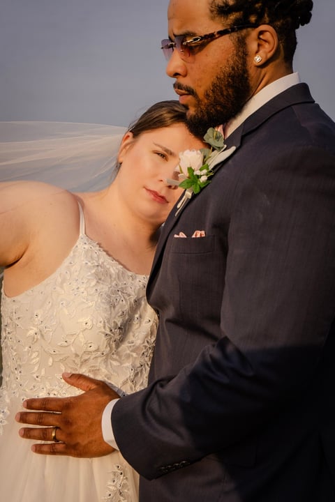 Bride and groom in formal wedding attire posing together