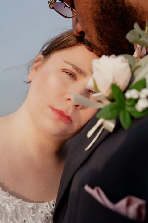 Close-up portrait of a woman resting her head against a mans shoulder